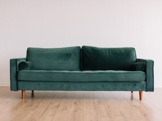 cool-hipster-green-couch-sofa-with-brown-wooden-legs-on-wooden-floo