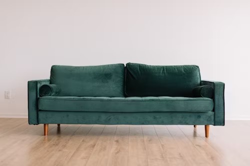 cool-hipster-green-couch-sofa-with-brown-wooden-legs-on-wooden-floo-big-0